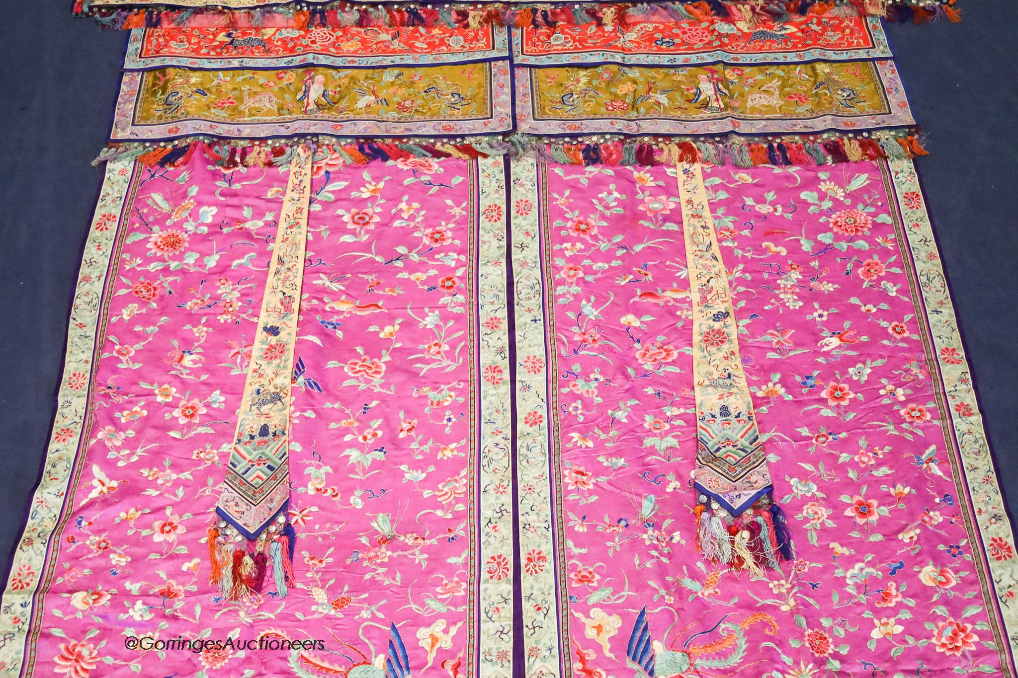 A pair of 20th century Chinese silk embroidered ceremonial panels, possibly for a wedding, 228cm not including fringing, each panel width 80cm, with a matching pelmet, width 198cm